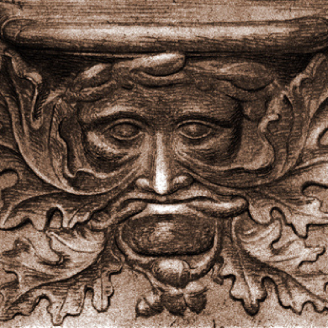 Green man carving with oak leaves growing out of face and mouth.